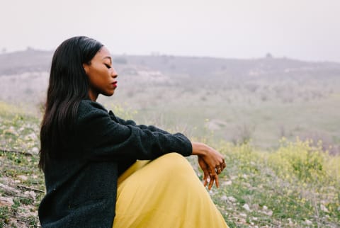 Woman Meditating in a Field in the Spring