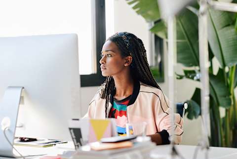 Woman Sitting at Her Desk Working