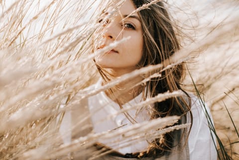 Woman Sitting in Field