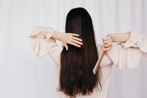 woman brushing long hair