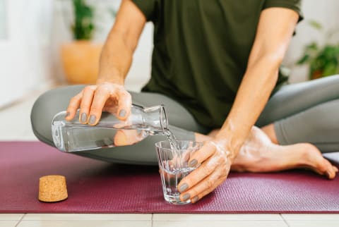 Woman pouring water into a glass