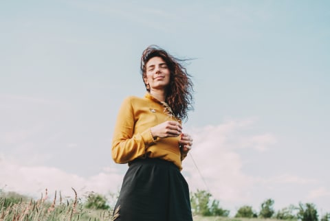 Smiling Relaxed Woman in a Field