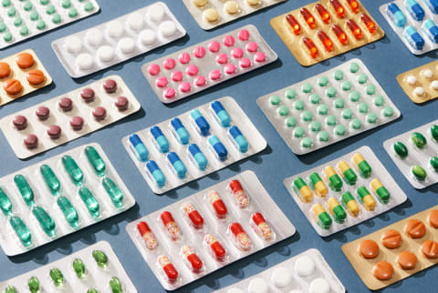 Many Colorful Pills Isolated On Blue