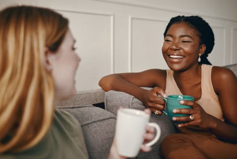 two women drinking coffee