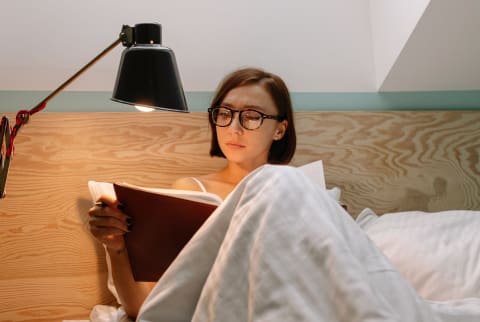 Woman Reading Diary Before Bedtime
