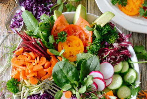 Super Salad With Spinach, Carrots, Cabbage, Radishes, Cucumbers, Peppers, Broccoli, and Tomatoes