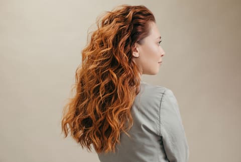 Beauty portrait of woman with beautiful red curly hair