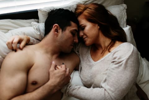Couple cuddling in bed