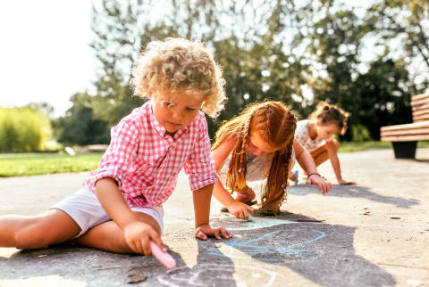 Kids Playing Outside and Drawing with Sidewalk Chalk