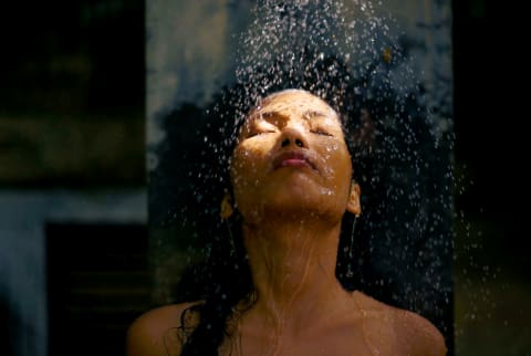 Woman with eyes closed in shower
