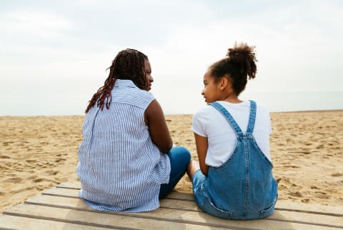 Mother and Daughter Talking on the Beach