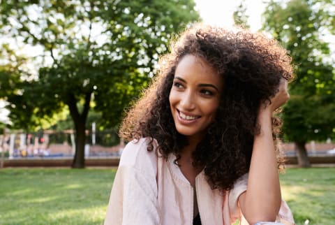 woman smiling with lush, curly hair 