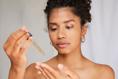 Woman Applying Cleansing Oil to Face