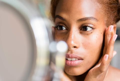 woman looking in mirror