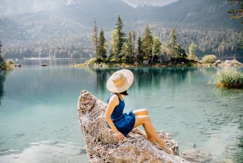 Young Woman On A Rock With The Beautiful Scenery Young Woman On A Rock With The Beautiful Scenery