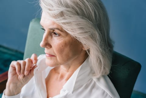 Older Woman Sitting in Thought