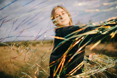 Peaceful Woman With Shiny Confetti On Meadow