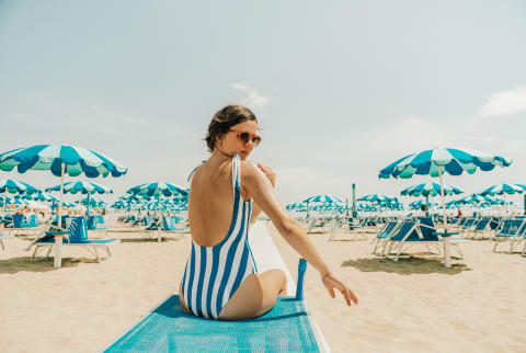 Woman Applying Sunscreen at the Beach