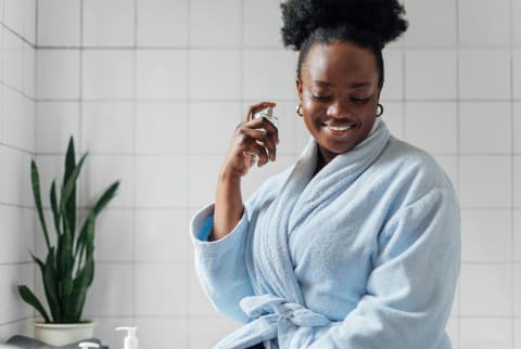 woman spraying perfume