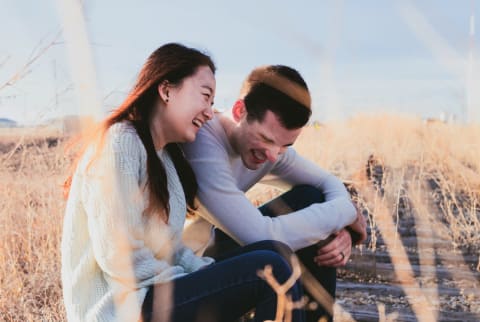 two people sitting outside together