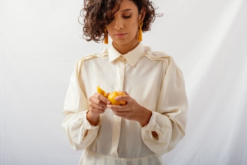 Woman Holding an Orange