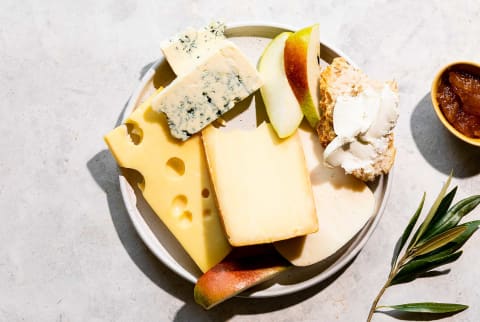 Plate with a variety of cheeses and fruits