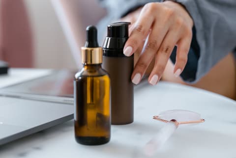 A Woman Using Essential Oil Products