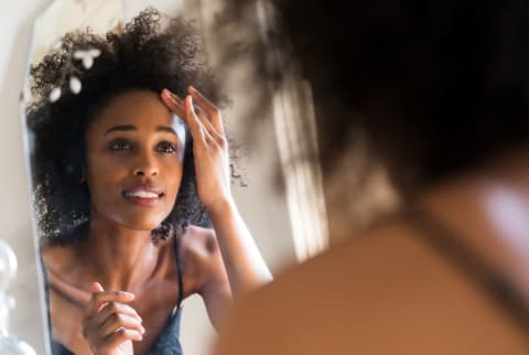 woman looking in the mirror