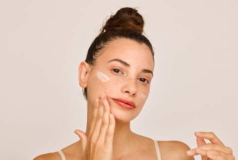 woman applying face cream