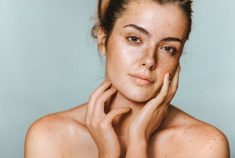 Woman with Freckles and Dewey Skin