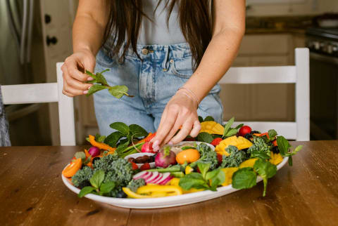 Woman putting food on a plate