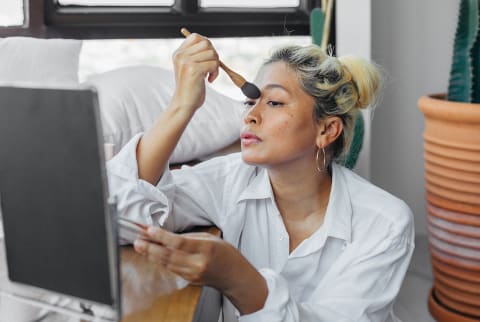 Woman applying makeup