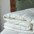 folded white comforter on bed