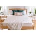 Spindle Mattress in bedroom with blanket and throw pillows on wood bed frame