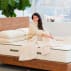 woman sitting on mattress in bright room