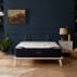 dreamcloud luxury hybrid mattress in navy blue room on platform bed