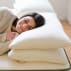 woman sleeping happily on plush pillow