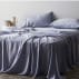bed with soft, draping navy sheet set
