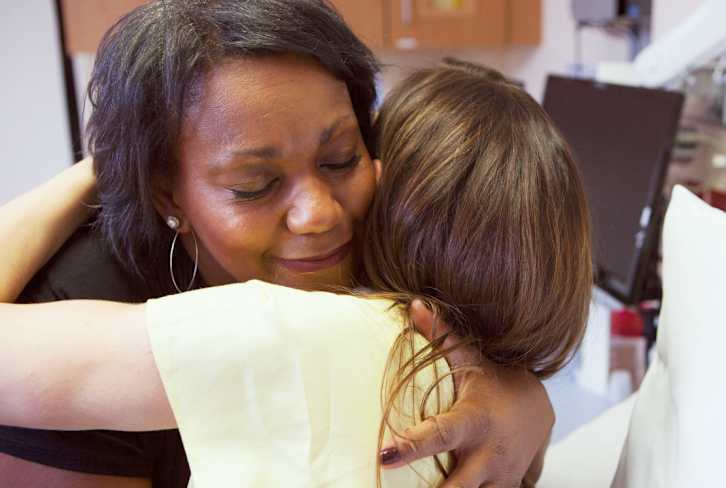 This Integrative Neurologist Hugs Her Patients (And There's A Science-Backed Reason Why)
