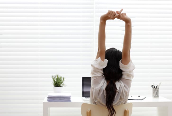 Stuck At Work? 6 Pilates Exercises You Can Do At Your Desk