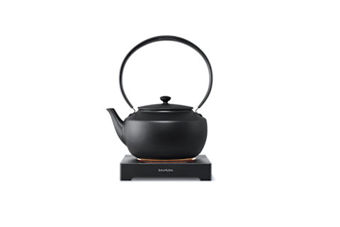 matte black tea kettle resting on a flat warming base from BALMUDA