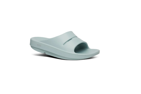 Oofos Women's OOahh Slide Sandal features a wide, two-strap upper and a thick, curved, contoured foam sole designed for impact absorption and recovery