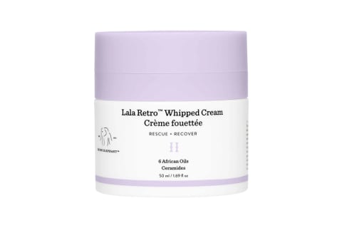 white jar of face cream with purple lid
