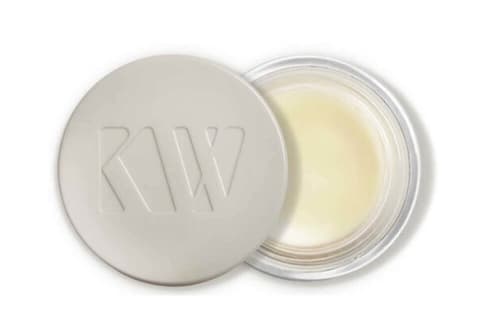 Kjær Weis eye balm in a clear container with white vegetabe plastic lid