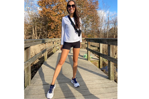 Author wearing asics sneakers on fall day on bridge Author wearing asics sneakers on fall day on bridge