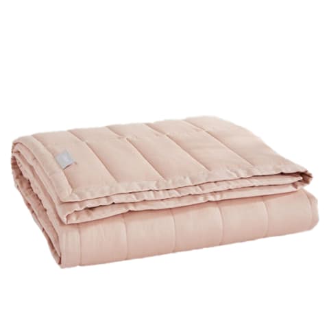 Folded, light pink weighted blanket from Casper. Folded, light pink weighted blanket from Casper.