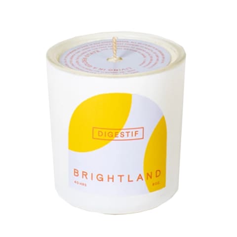white candle with yellow geometric pattern