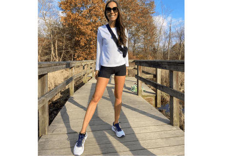 Author wearing asics sneakers on fall day on bridge