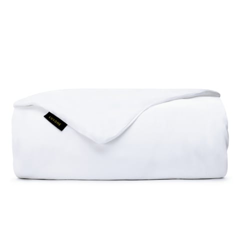 White weighted blanket with black tag, folded. 