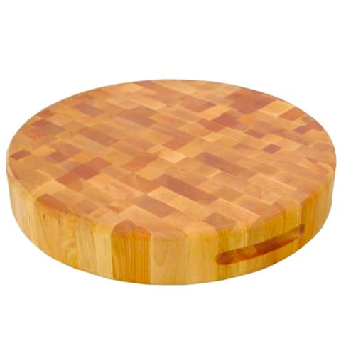 circular wooden cutting board in light yellow wood